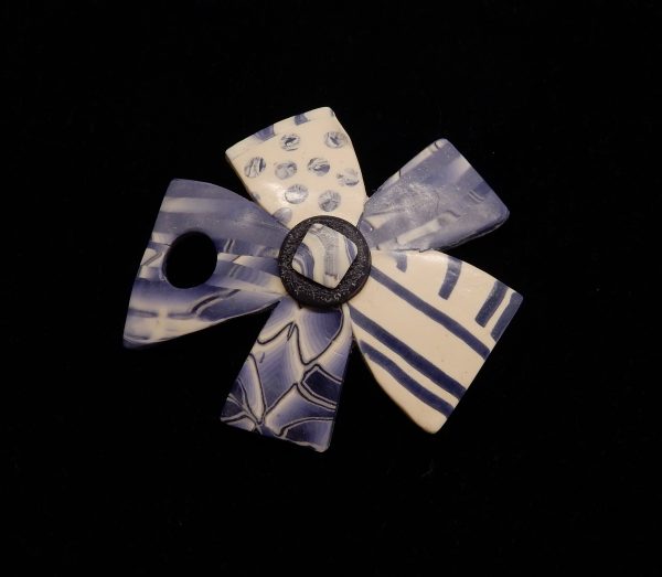 Purple and white flower polymer brooch.